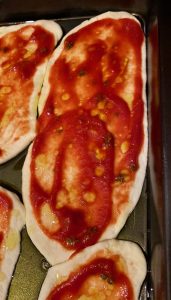 Semolina pizza tongues display on an oiled baking tray ready for the oven
