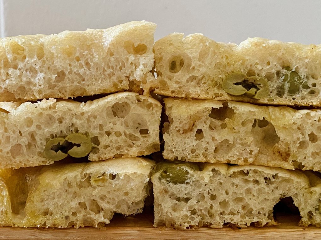 Homemade focaccia with olives cut into slices