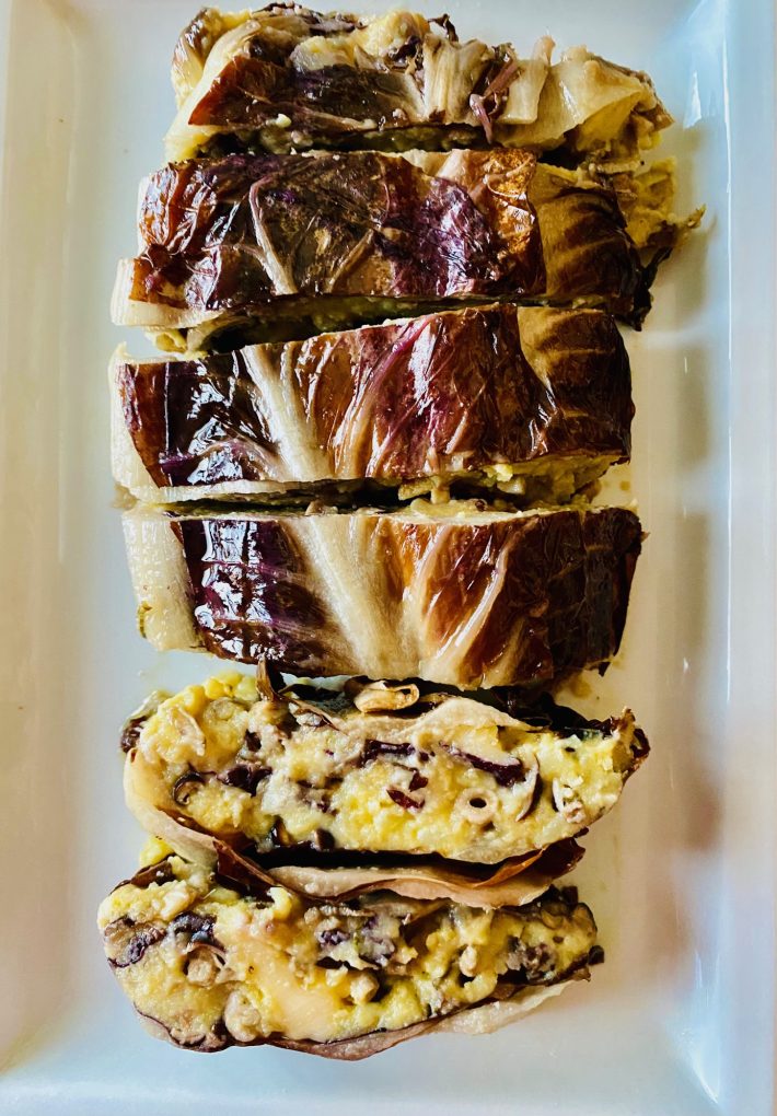 Sliced rustic potato and mushroom bake wrapped in radicchio leaves